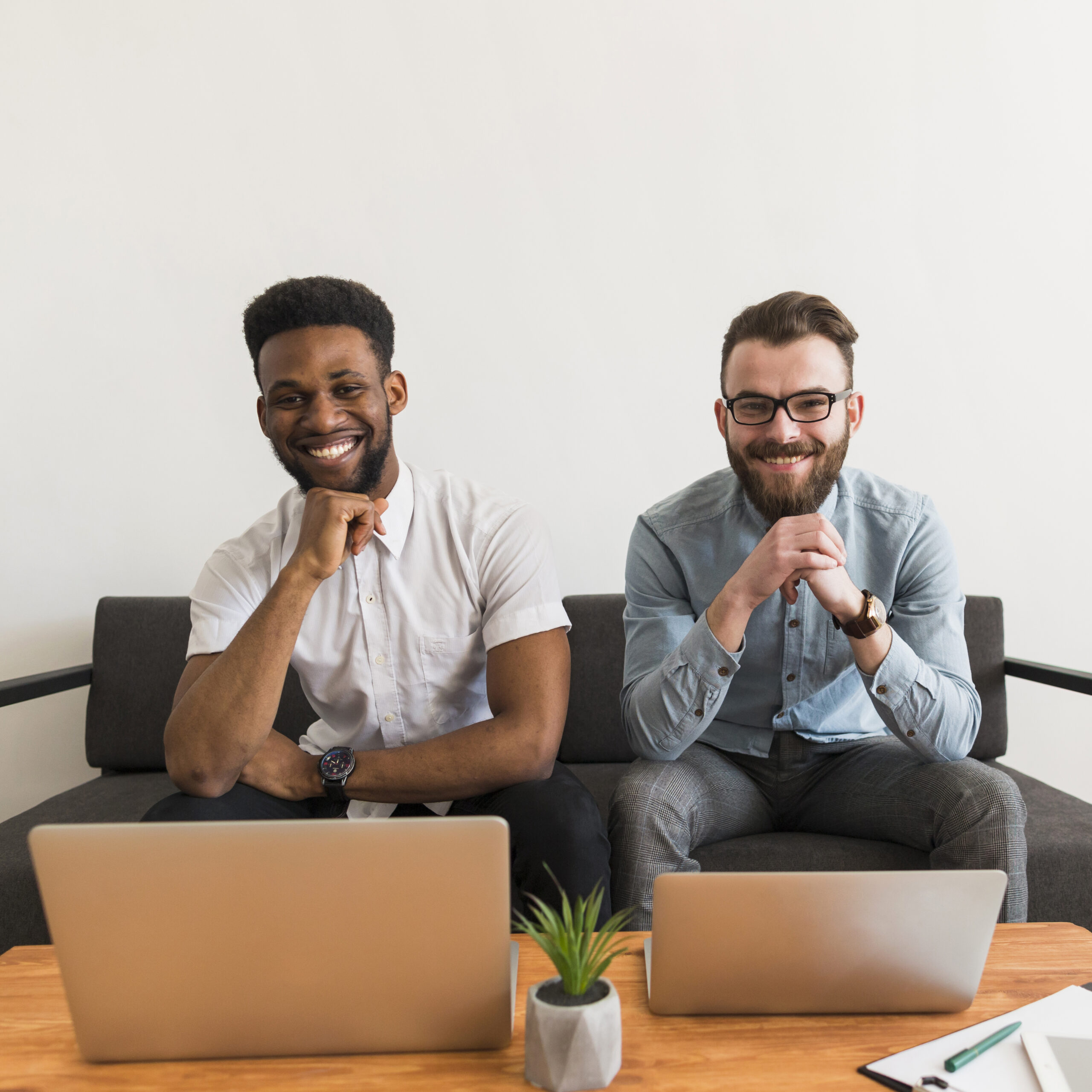 cheerful-men-near-laptops cheerful-men-near-laptops